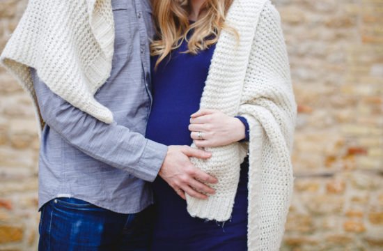 Expecting mom with blanket wrapped around her at St. Norbert Ruins