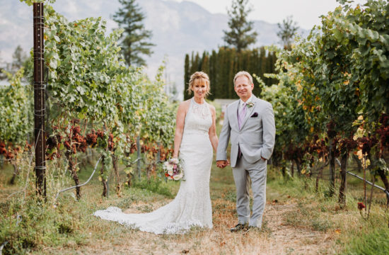 Bride and groom standing in vineyard at Off the Grid Winery Kelowna