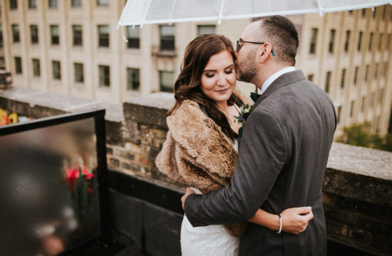 Bride and groom on rooftop of Winnipeg Exchange District