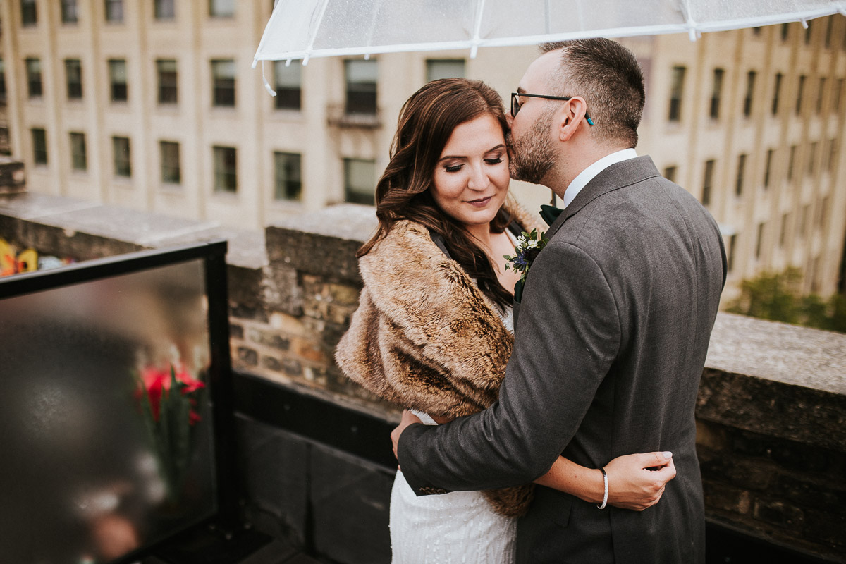 Bride and groom on rooftop of Winnipeg Exchange District
